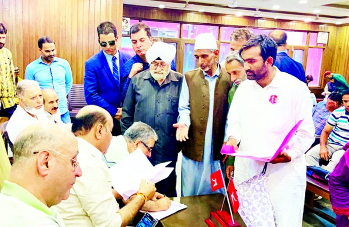 Deputy CM, Surinder Choudhary listening to the issues raised by various delegations in Srinagar on Friday.