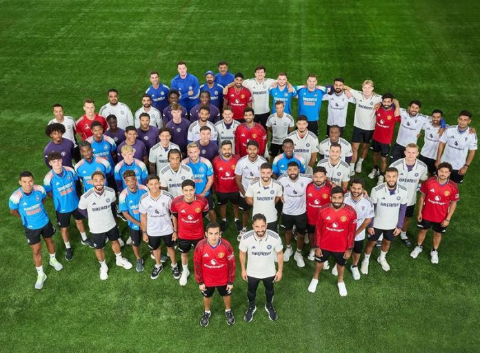 Indian cricket team and Manchester United football team posing for a group photograph. Indian cricket team and Manchester United football team posing for a group photograph.