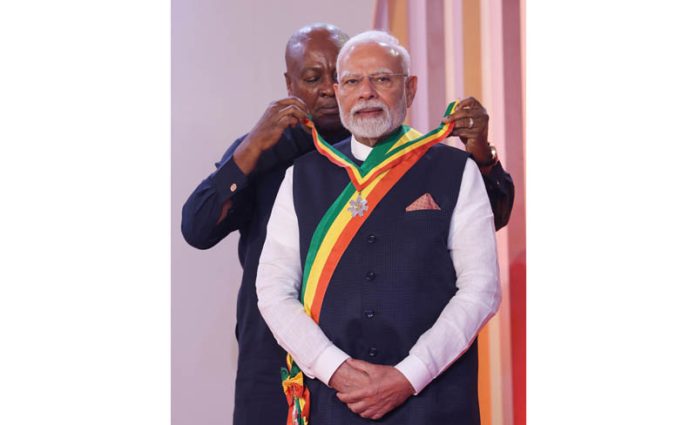 Prime Minister Narendra Modi being conferred with The Officer of the Order of the Star of Ghana, the country's national honour by the Ghanaian President John Dramani Mahama in Accra. (UNI)