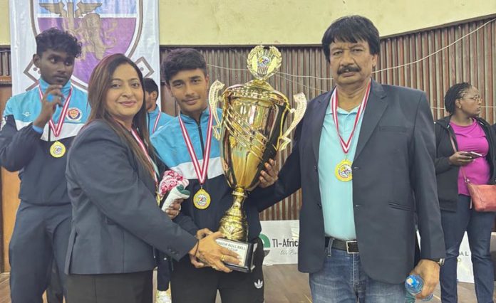 Utkarsh Gupta along with coaching staff Rita Rehan and Madhu Sharma posing with Roll Ball World Cup 2025 trophy.