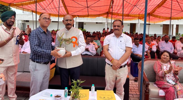MLA Akhnoor Mohan Lal Bhagat being greeted with a sapling during the inauguration of KV building in Jourian on Tuesday.