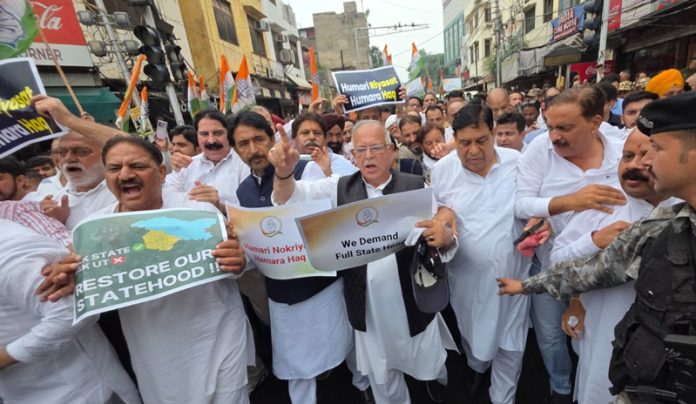 Congress leaders and workers taking out protest march in Jammu for Statehood to J&K on Sunday. -Excelsior/Rakesh