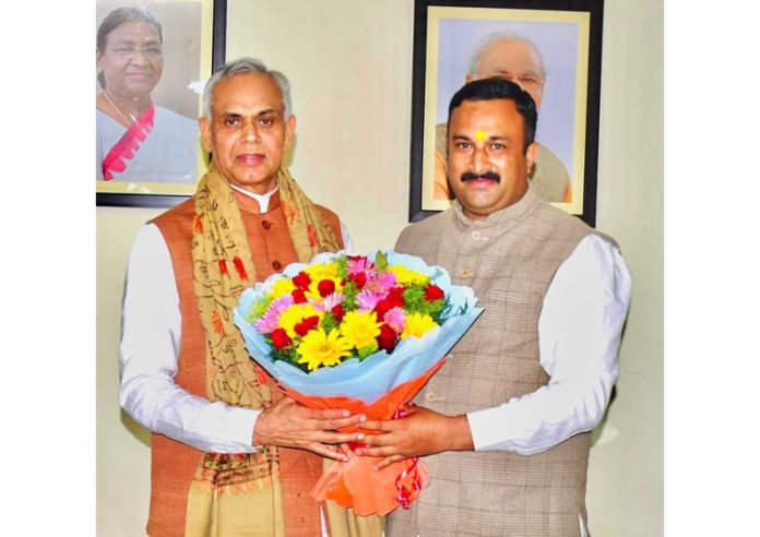 Mahant Rohit Shastri presenting a bouquet to Gujarat Governor Acharya Devvrat at Raj Bhavan, Jammu.