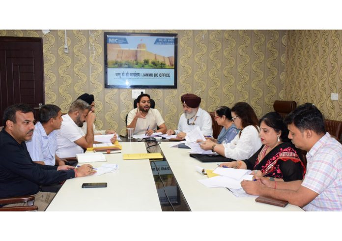 DC Jammu chairing a meeting on Monday.