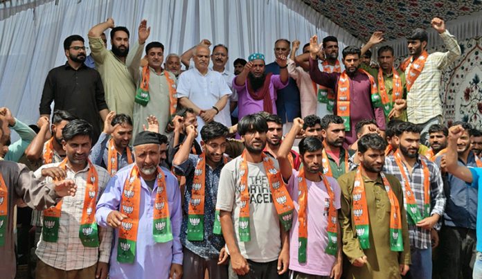 The new entrants who joined BJP at Handwara on Saturday posing for a photograph with party general secretary (Org) Ashok Koul and other leaders.