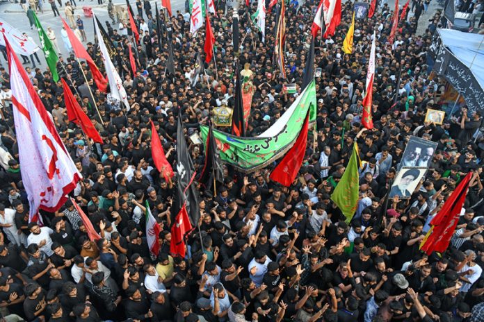 Mourners marching during 8th Muharram procession in Srinagar on Friday. — Excelsior/Shakeel Mourners marching during 8th Muharram procession in Srinagar on Friday. — Excelsior/Shakeel