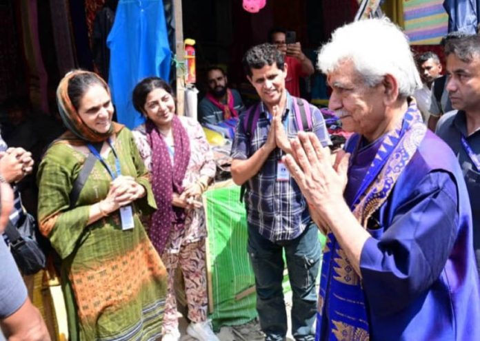 LG Manoj Sinha meeting pilgrims at Nunwan base camp on Monday.