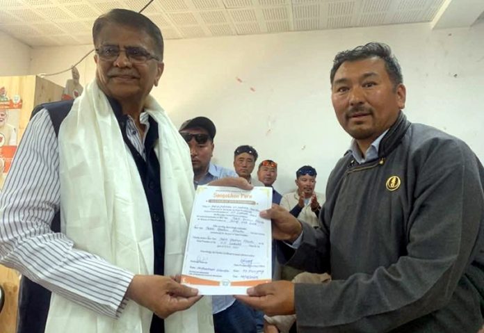 Newly elected BJP president Tashi Gyalson Kachu receiving appointment letter in Leh on Wednesday.