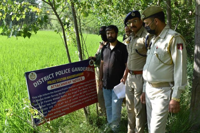 Police attaching property of a terrorist.