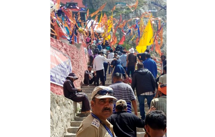 Pilgrims in long queues ascending the stairs at holy cave for darshan of naturally formed Ice Lingam on Sunday. Pilgrims in long queues ascending the stairs at holy cave for darshan of naturally formed Ice Lingam on Sunday.