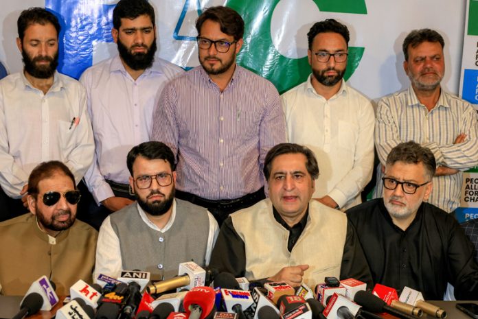 PC president Sajjad Gani Lone along with other leaders during a press conference in Srinagar on Monday.