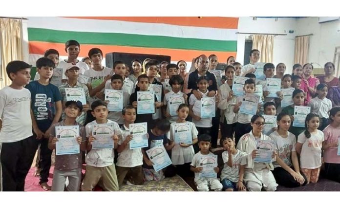 Judo players posing along with certificates. Judo players posing along with certificates.