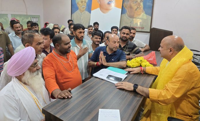 MLA Yudhvir Sethi interacting with people during a public grievances camp in Jammu.