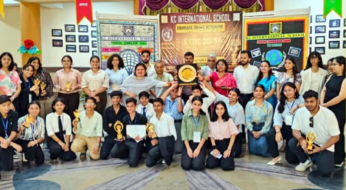 Students posing along with trophies during a programme. Students posing along with trophies during a programme.