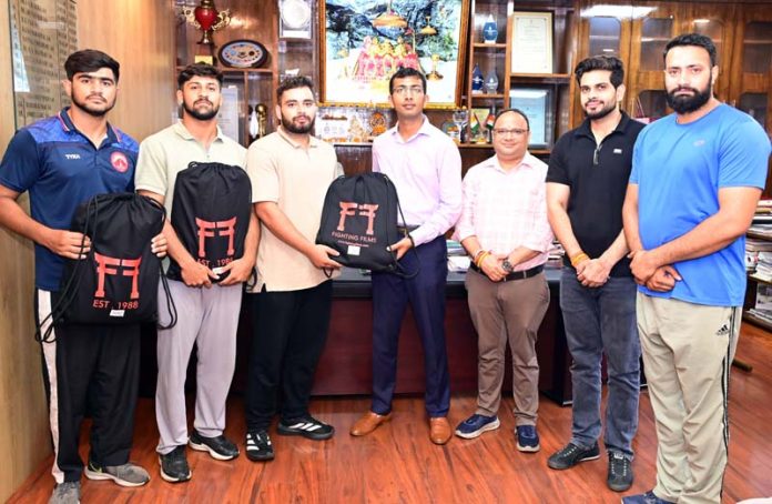 Chief Executive Officer Shri Mata Vaishno Devi Shrine Board Anshul Garg presenting judo kits to athletes.