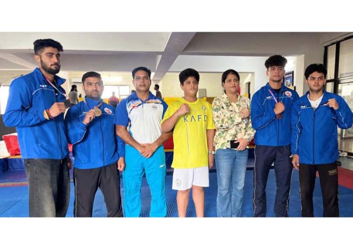 Medallists posing along with dignitaries.