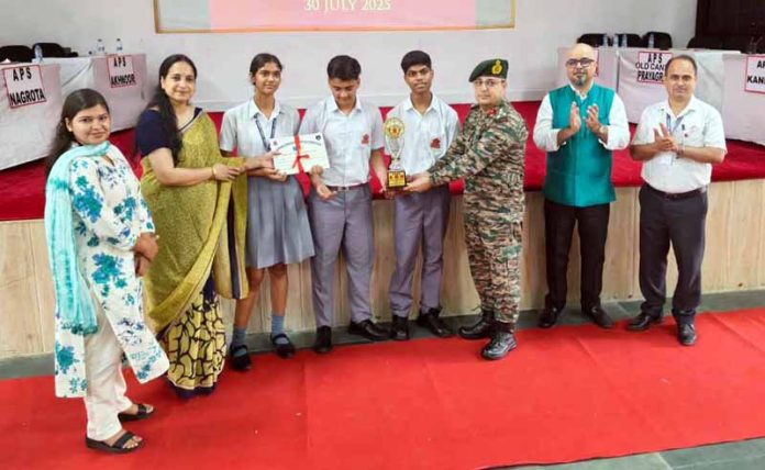 Officer presenting trophy to a winning team.