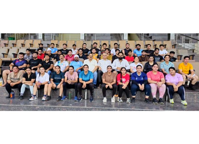 Weightlifters posing along with dignitaries during conditioning camp.