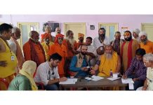 HoD Cardiology GMC & SSH Jammu Dr Sushil Sharma examining Sadhus at Ram Mandir, Purani Mandi on Sunday.