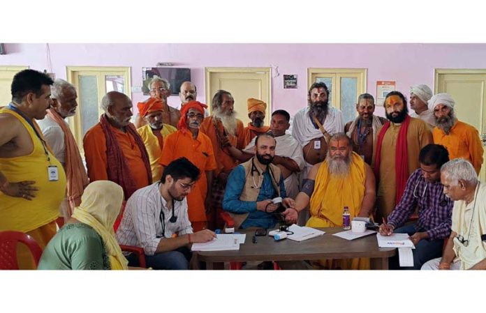 HoD Cardiology GMC & SSH Jammu Dr Sushil Sharma examining Sadhus at Ram Mandir, Purani Mandi on Sunday.