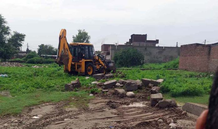 A JCB demolishing illegal structures in Gole area of Jammu.