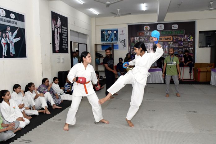 Girls in action during a boxing match at MA Stadium.