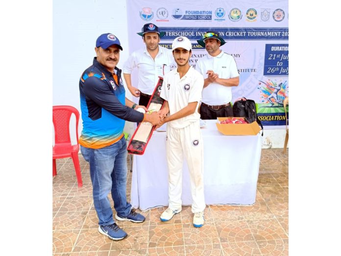 Dignitary presenting cricket bat to a player.