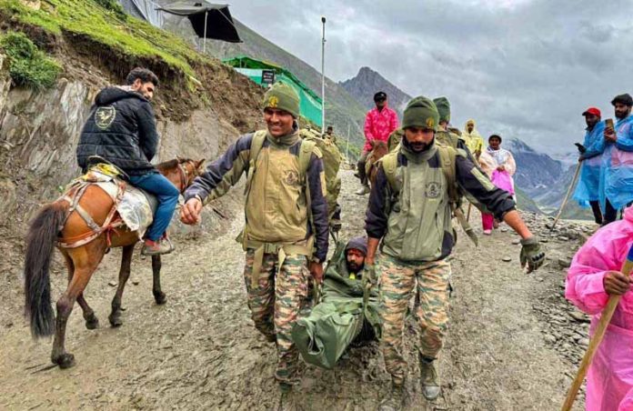 An Amarnath Yatri being shifted to local medicare centre by Indian Army jawans near Kali Mata on Tuesday.