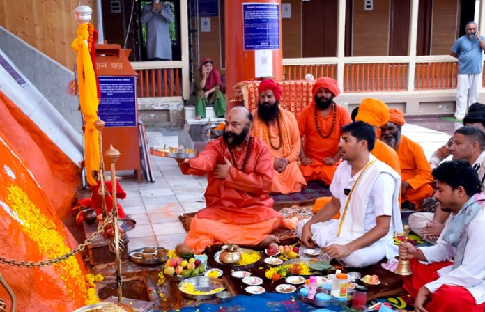 Mahant Deependra Giri Ji along with other Sadhus and devotees performing Puja at Sharika Bhawani temple Srinagar on Friday. -Excelsior/Shakeel