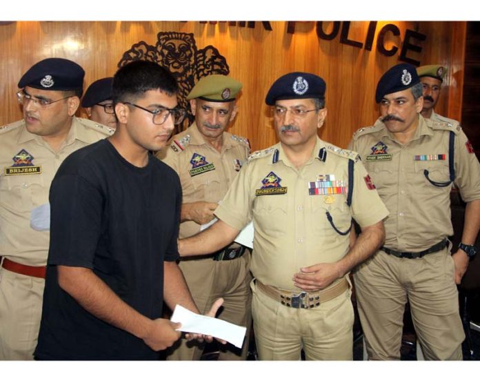 SSP Jammu, Joginder Singh handing over a cheque to a fraud victim at DPL Jammu on Wednesday. -Excelsior/Rakesh