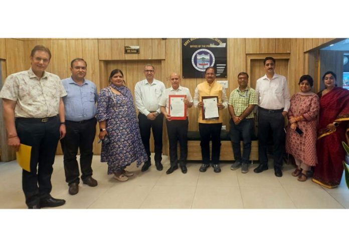 CUJ Vice-Chancellor and Principal GMC Jammu display copies of MOU signed by them.