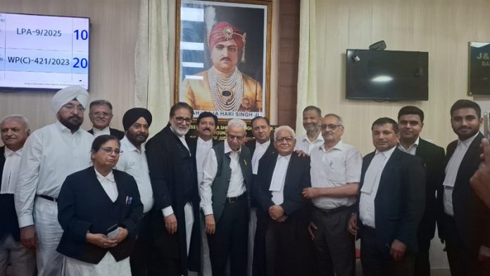 Lawyers posing for a group photograph after unveiling the portrait of Maharaja Hari Singh at the High Court Complex in Jammu on Monday.