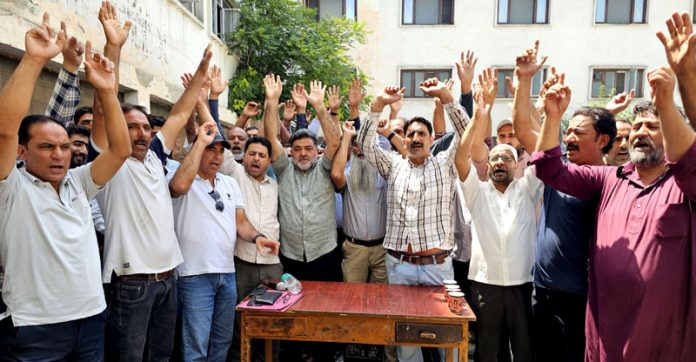 J&K Road Transport Corporation employees raising slogans after meeting on Monday. — Excelsior/Shakeel J&K Road Transport Corporation employees raising slogans after meeting on Monday. — Excelsior/Shakeel