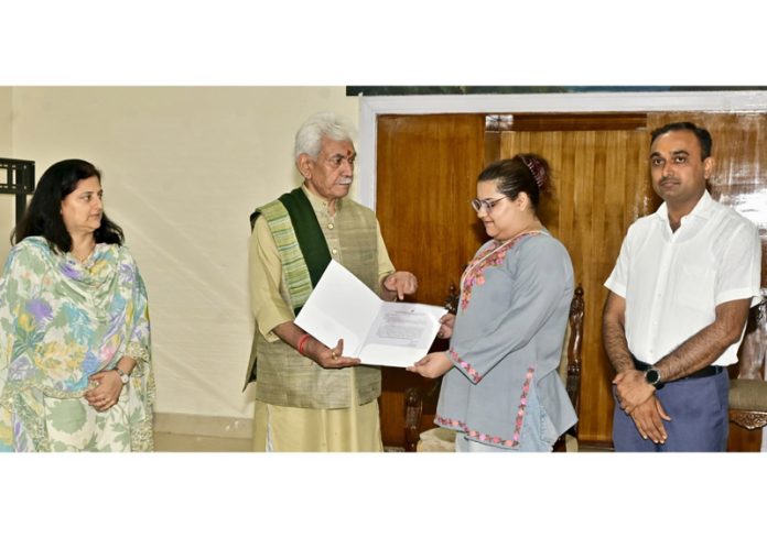 LG handing over job assurance letter to daughter of ADDC Rajouri, Dr Raj Kumar Thapa on Monday.