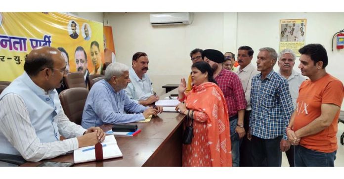 MLAs Sham Lal Sharma and Mohan Lal Bhagat listening public grievances at BJP office, Trikuta Nagar on Friday.