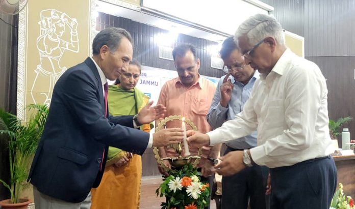 Justice (Retd) Tashi Rabstan lighting ceremonial lamp during inauguration of Viksit Bharat Yuva Connect Prog at JU on Thursday. - Excelsior/Rakesh