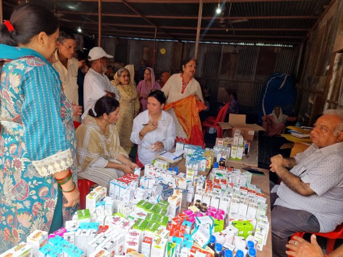 Doctors and patients during a health camp at Jorh Camp in Udhampur.