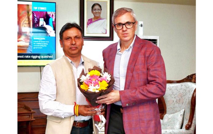 MLA Kathua greets CM Omar Abdullah with a flower bouquet during their meeting in Srinagar on Thursday.