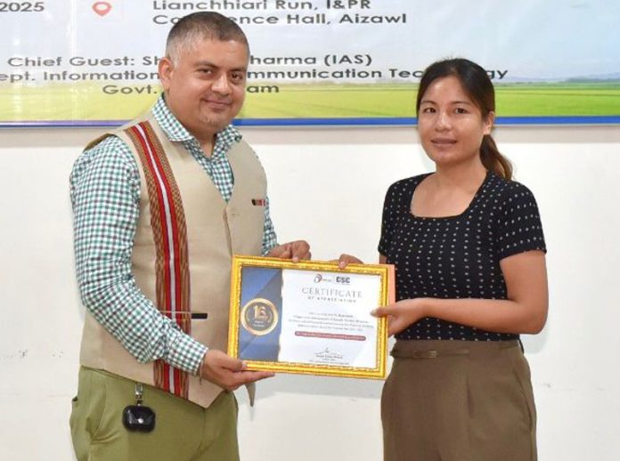 Amit Sharma awarding a VLE in Aizwal on Saturday.