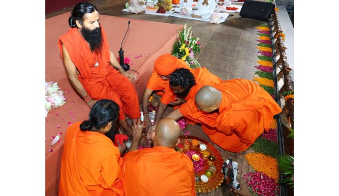 Disciples of Swami Ramdev seeking blessings from their mentor on Guru Purnima at Haridwar on Thursday. Disciples of Swami Ramdev seeking blessings from their mentor on Guru Purnima at Haridwar on Thursday.