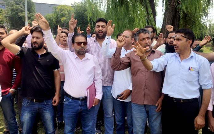 JKTDC employees protesting at Srinagar on Tuesday. -Excelsior/Shakeel