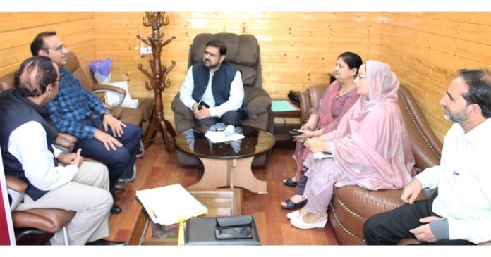 Minister Satish Sharma meeting officers at Srinagar on Thursday.