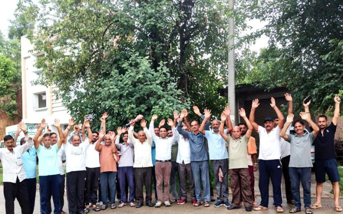 People protesting at Dhangri in Rajouri against PDD authorities. -Excelsior/Imran