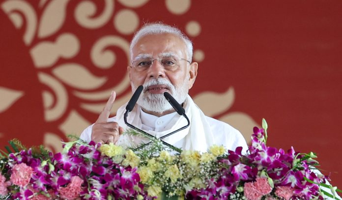 Prime Minister Narendra Modi addressing the gathering at a public event held at Varanasi on Saturday. (UNI)