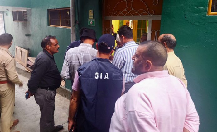 An SIA team during raid at a house on Tuesday. An SIA team during raid at a house on Tuesday.