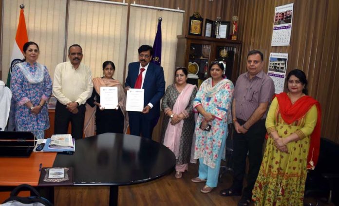 Officers displaying copies of MoU between NISM and Cluster University of Jammu.