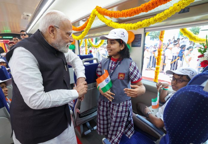 Prime Minister Narendra Modi interacts with children in Vande Bharat Express train at KSR Railway Station in Bengaluru, Karnataka on Sunday. (UNI)