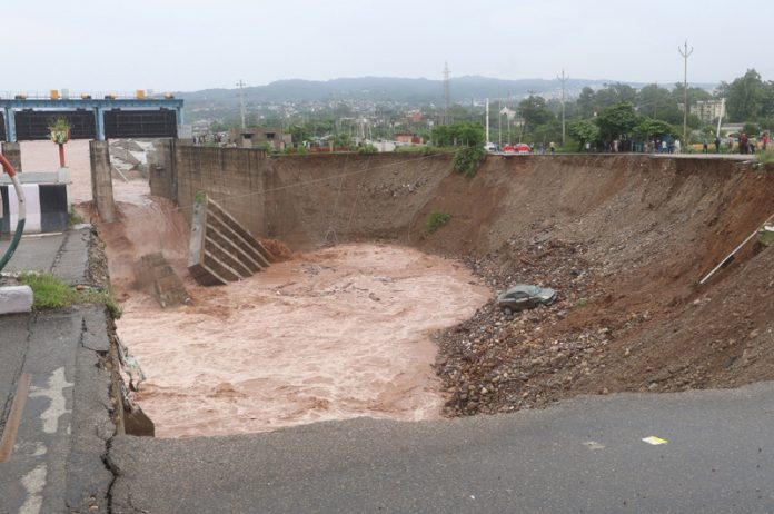 A caved in portion of approach road to 4th Tawi Bridge in Jammu. -Excelsior/Rakesh