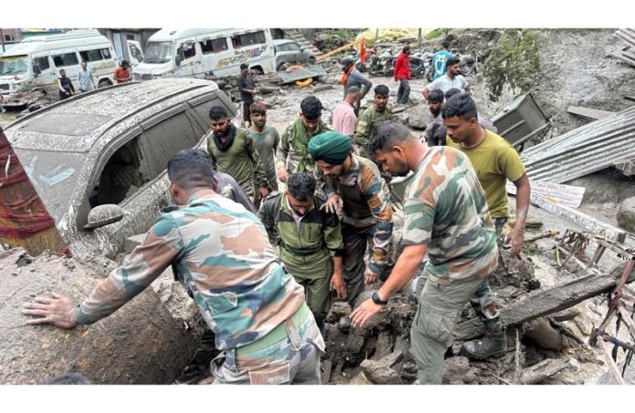 Army personnel conduct a search and rescue operation at cloudburst hit Chashoti village in Kishtwar on Saturday.