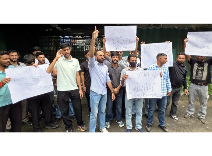 PET aspirants staging protest outside Press Club, Jammu. -Excelsior/Rakesh PET aspirants staging protest outside Press Club, Jammu. -Excelsior/Rakesh